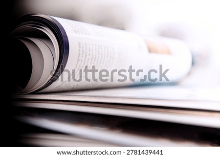 stack of open magazines on white background
