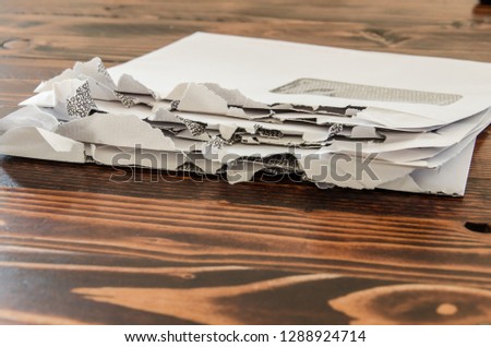 Stack of opened envelopes laying on wooden table. Pile of letters with window.