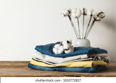 A stack of organic clothing and cotton colors. Eco friendly fabric shop.