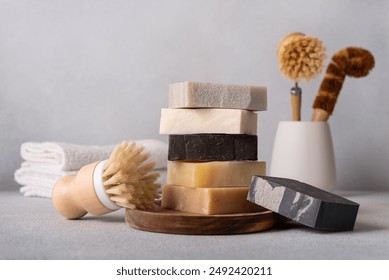 Stack of organic soap bars and bamboo dish brushes. Kitchen cleaning concept.