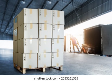 Stack of Package Boxes on Pallet Load with Shipping Cargo Container. Truck Parked Loading at Dock Warehouse. Delivery. Supply Chain Shipment Boxes. Warehouse Logistics. Cargo Freight Truck Transport.