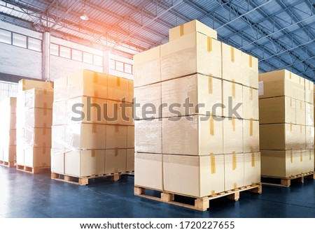 Stack of Package Boxes on Wooden Pallets. Interior of Storage Warehouse. Supply Chain Cardboard Boxes. Cargo Shipment Export-Import. Shipping Warehouse Logistics.