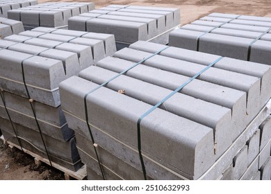 Stack of packed border stones for asphalt road on wooden pallet