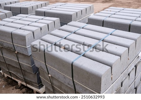 Stack of packed border stones for asphalt road on wooden pallet