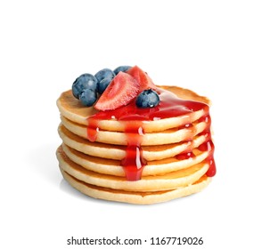 Stack of pancakes with berries and syrup on white background