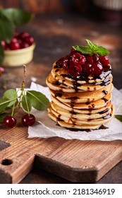 Stack Of Pancakes With Cherries And Chocolate Syrup. Breakfast For The Family. 