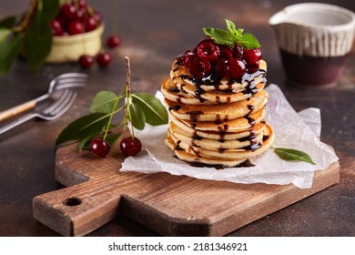 Stack Of Pancakes With Cherries And Chocolate Syrup. Breakfast For The Family. 