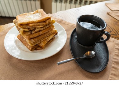 Stack Of Pancakes, Dark Mug And Coffee Pot On Wooden Table. Side View Selective Focus