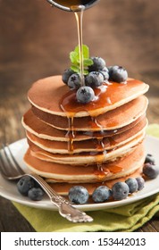 Stack Of Pancakes With Fresh Blueberry And Maple Syrup