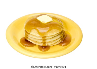 Stack of pancakes with maple syrup and butter on plate.  Isolated on white background with clipping path.