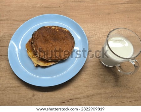 A stack of pancakes sits elegantly on a dainty plate, beckoning to be enjoyed.