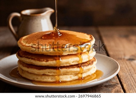 Stack of pancakes with syrup dripping