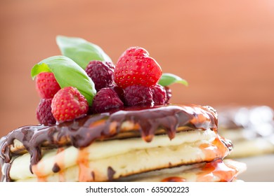 Stack of pancakes topped with berry jam. Prepared for breakfast. Lots of berries on top of the stack