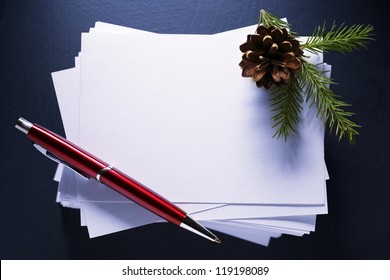 Stack Of Paper Cards And Twig Of Evergreen Fir