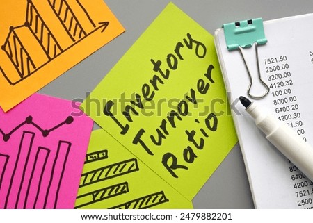 Stack of papers with charts and inventory turnover ratio.