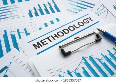 Stack of papers with data and word methodology.