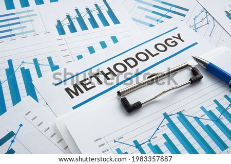 Stack of papers with data and word methodology.