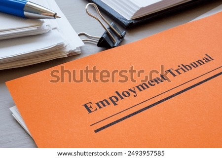 Stack of papers and employment tribunal documents.
