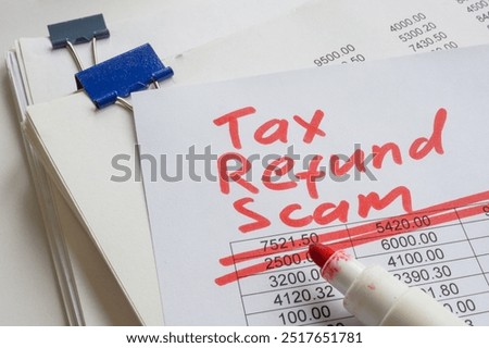 Stack of papers with the label tax refund scam.