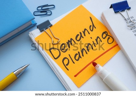 Stack of papers on demand planning.