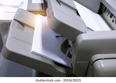 Stack Of Papers On Tray Of The Copy Machine, Focus On Bottom Tray