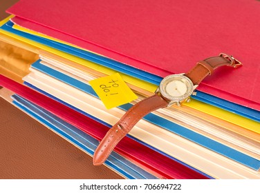 Stack Of Papers With A Watch And To Do Sticky Note, A Well Organized Work Area With To Do Tasks 