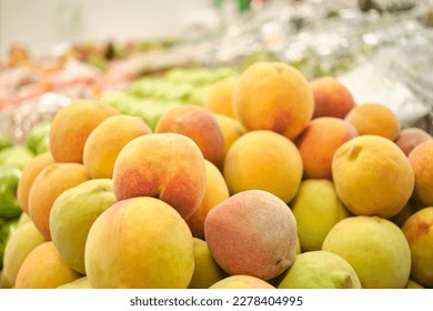 Stack of peaches in a fruit store. Bright image with copy space.