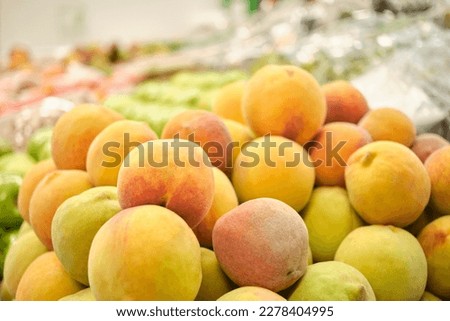 Stack of peaches in a fruit store. Bright image with copy space.