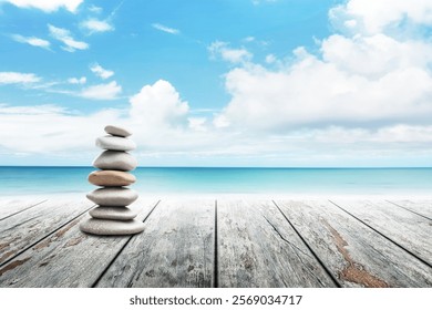 Stack of pebble stones at the beach on a wooden surface. Concept Zen, Spa, Summer, Beach, Sea, Relax.