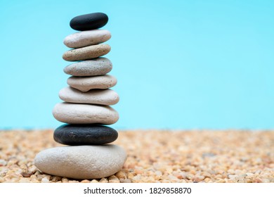 Stack of pebbles in an unstable state. A pyramid made of flat stones. 