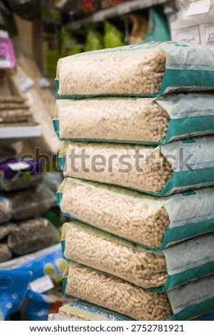 Stack of pet bedding blocks displayed in a store aisle. Pet supplies, retail, variety, store interior, shopping