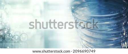 stack of petri dish for microbiology lab research in blue medical science information banner background