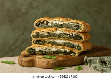 Stack of pie slices. Erbazzone, also known as scarpazonne, a rustic pie made with leafy greens,  chard and spinach, ricotta and parmesan cheese, from Emilia Romagna, Northern Italy.