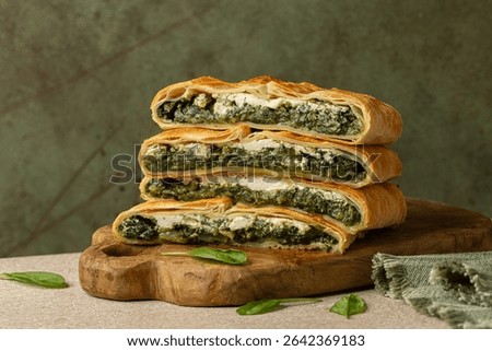 Stack of pie slices. Erbazzone, also known as scarpazonne, a rustic pie made with leafy greens,  chard and spinach, ricotta and parmesan cheese, from Emilia Romagna, Northern Italy.