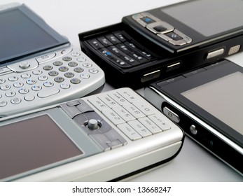 Stack Pile Of Several Modern Mobile Phones PDA Cell Handheld Units Isolated On White Background