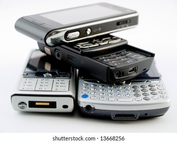 Stack Pile Of Several Modern Mobile Phones PDA Cell Handheld Units Isolated On White Background