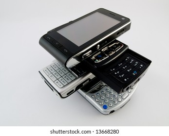 Stack Pile Of Several Modern Mobile Phones PDA Cell Handheld Units Isolated On White Background