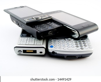 Stack Pile Of Several Modern Mobile Phones PDA Cell Handheld Units Isolated On White Background