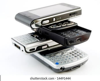 Stack Pile Of Several Modern Mobile Phones PDA Cell Handheld Units Isolated On White Background