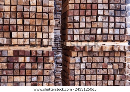 Stack pile of squared wood poles at construction site. Stacked timber for construction, stacks with pine lumber, wood harvesting shop, 