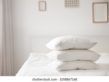 Stack Of Pillows On Bed