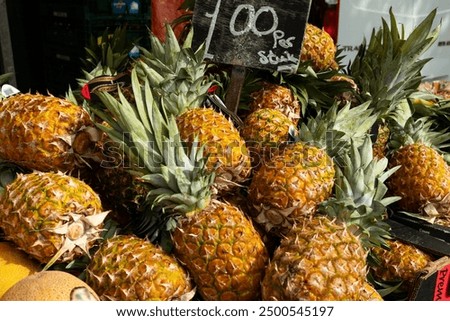 Stack of pineapple, weekly market at Rotterdam. Sweet fruit, raw, food, tasty, market stall, trading.