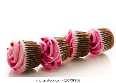 Stack of pink cupcakes on white background.