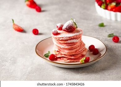 Stack of pink pancakes with strawberry. Pink colourful pancakes with berries. Breakfast - Powered by Shutterstock