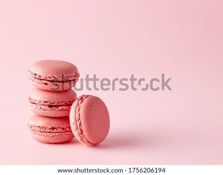 stack of pink strawberry macaroons on pink background