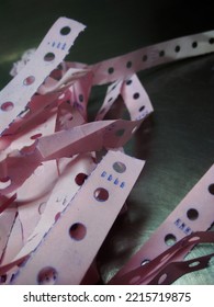 Stack The Pink Strips Of Paper With Holes In Them.