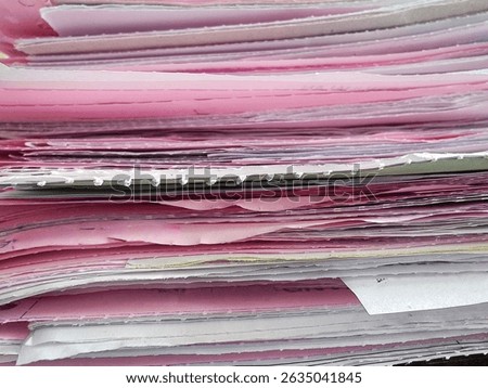 Stack of Pink and White Paper Documents in Office Showing Layers of Reports, Forms, and Administrative Files Close Up