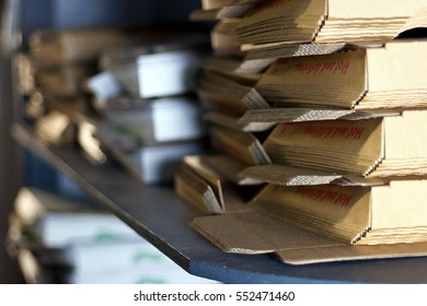 Stack Of Pizza Boxes On Shelf