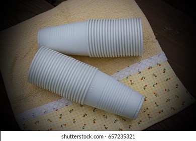 A stack of plastic cups on the background of a wooden table