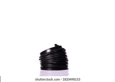 Stack of plastic disposable black top coffee caps for paper cups isolated on white background. Coffee to go, takeaway hot drinks, lids, ecology, recycling concept, environmental protection. Copy space